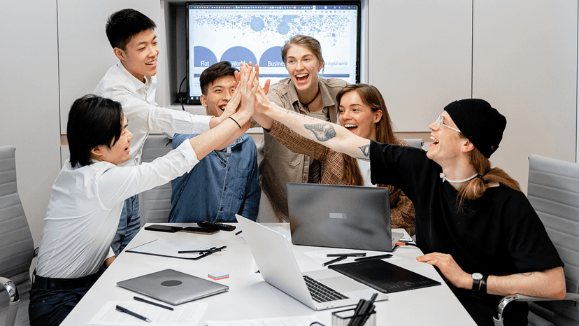Group of people cheering in meeting room